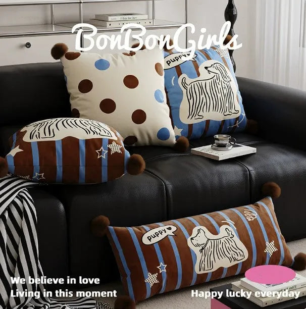 Blue cartoon animal print cushion pillow with removable cover on a grey sofa.