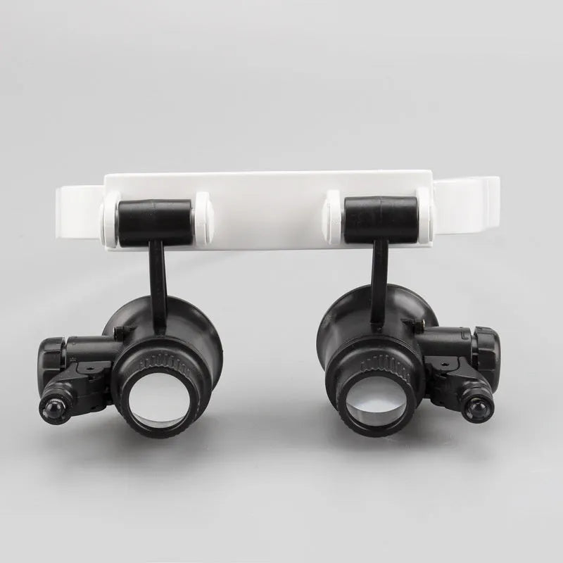 White head-mounted magnifying glass with LED light, shown both unfolded and folded for clock repair work.