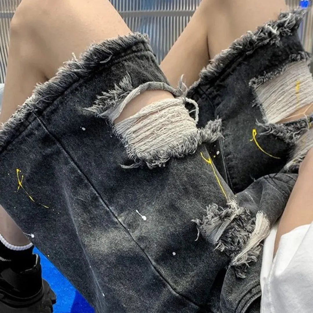 Men's loose-fit denim shorts with water-washed finish and distressed hole detailing in black colour
