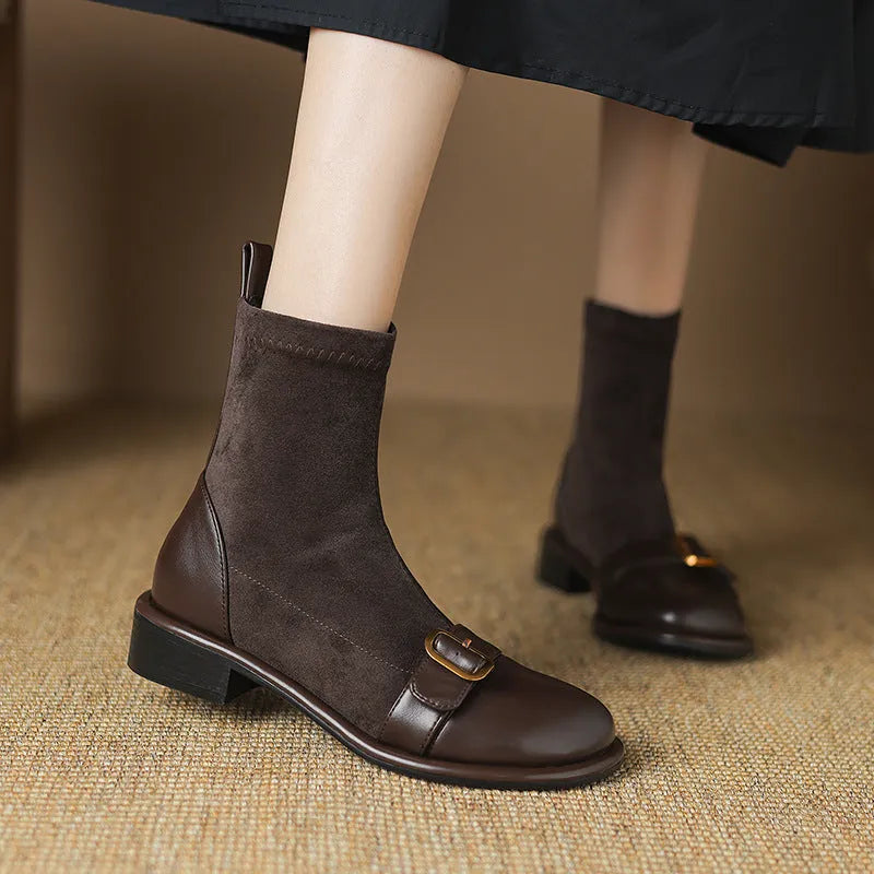Women's black low heel Martin boot with front lace-up and silver ankle buckle on a round toe.