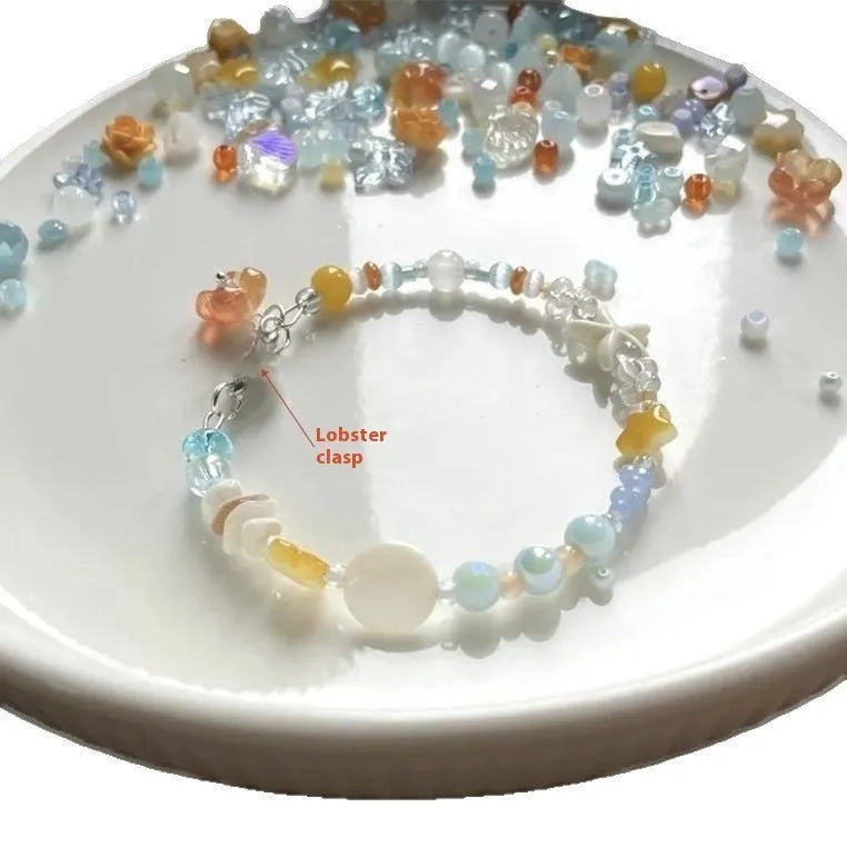 Orange alloy bracelet for women with a diamond shape and round decorative elements on a summer seaside theme.