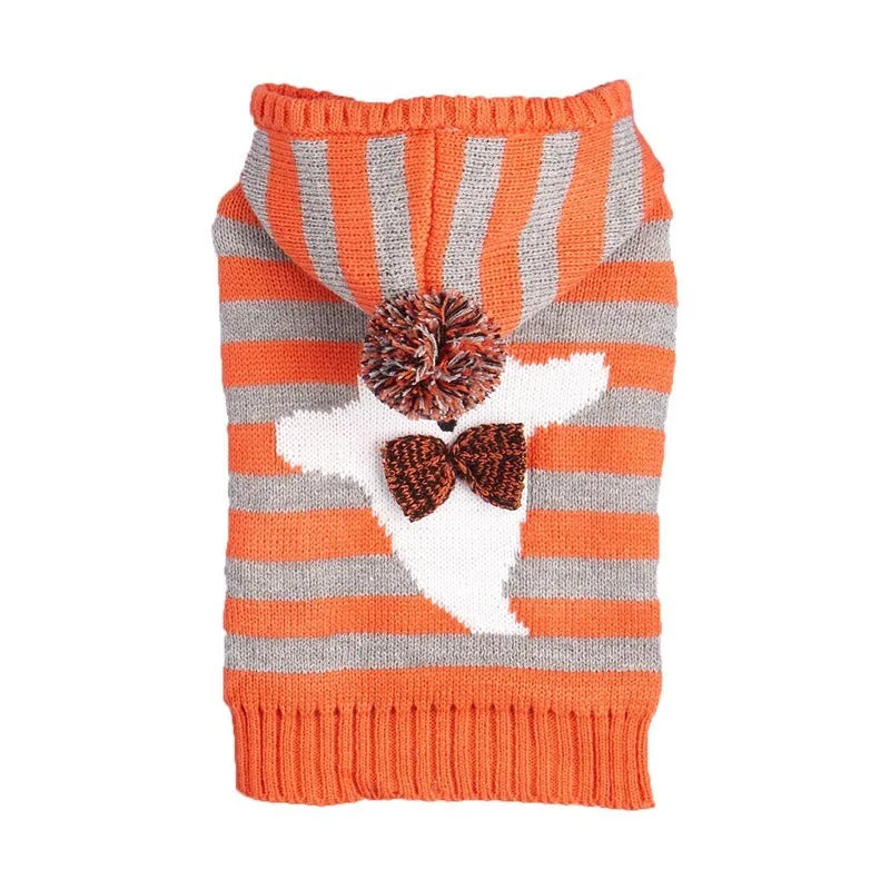 Orange knitted dog sweater with striped pattern, fur ball trim, and a hood for Halloween.