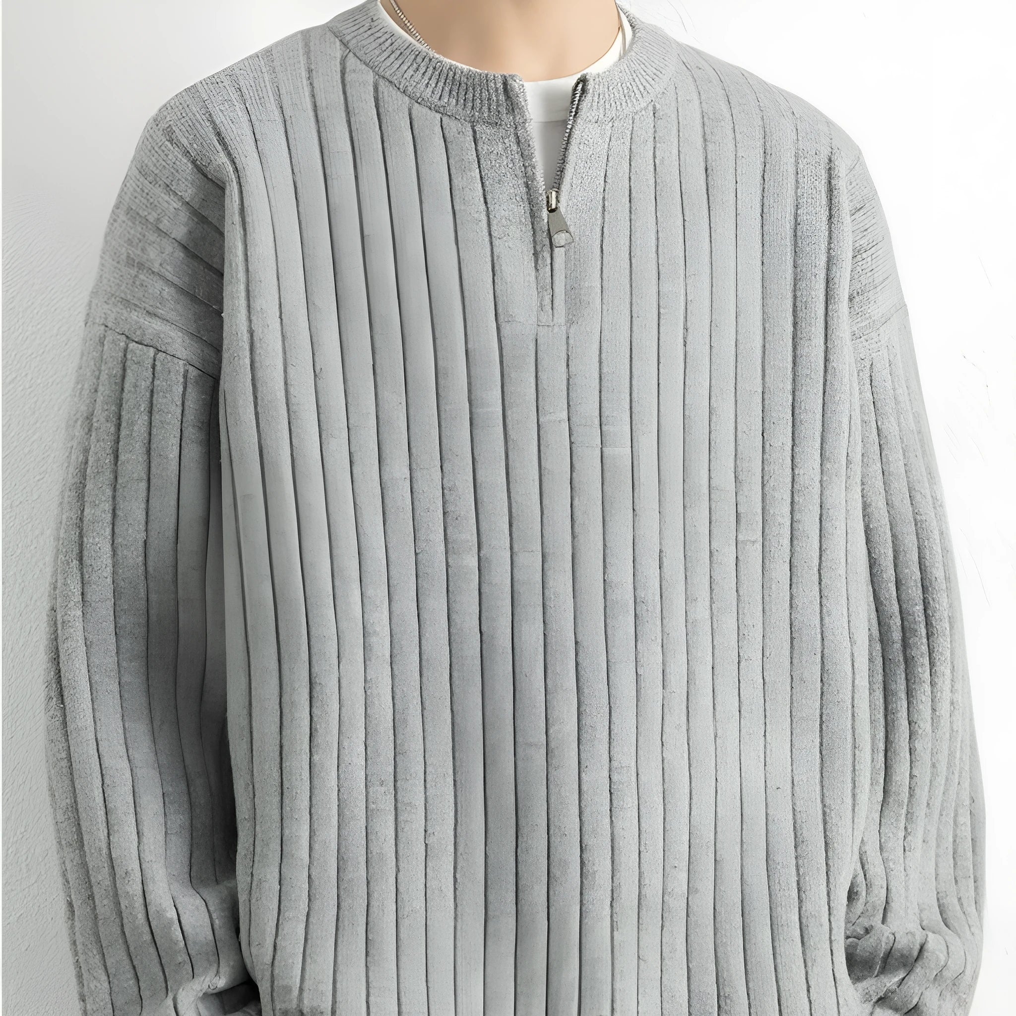 Man wearing a grey half-zip textured knit pullover sweater with a loose fit.