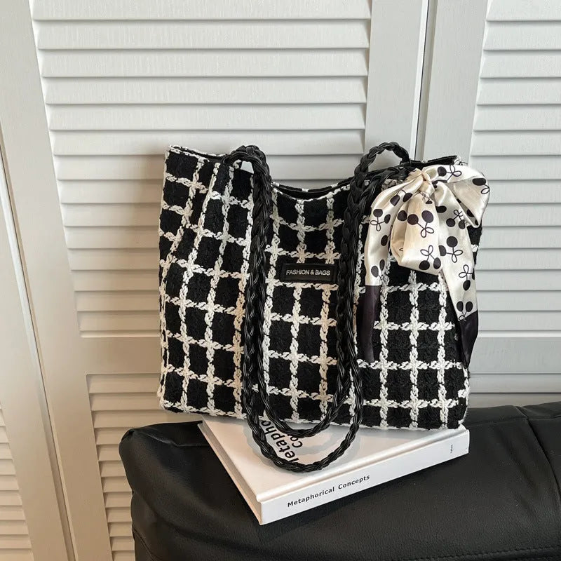 Black woolen shoulder bag with weaving details showing sandwich pocket exterior and interior organisation compartments