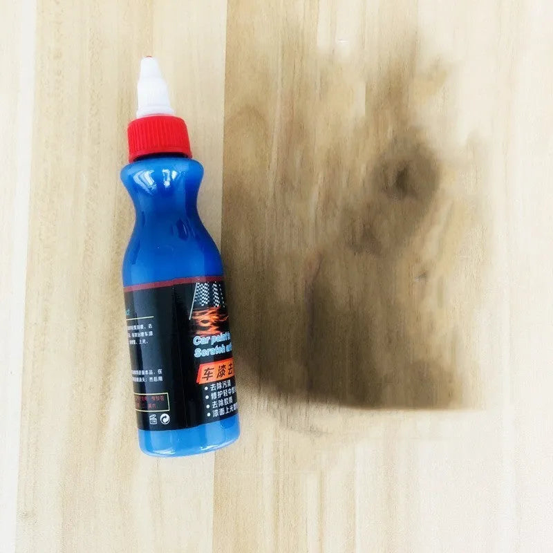 Small blue car wiping tool and bottle of scratch repair agent for DIY automotive scratch removal.
