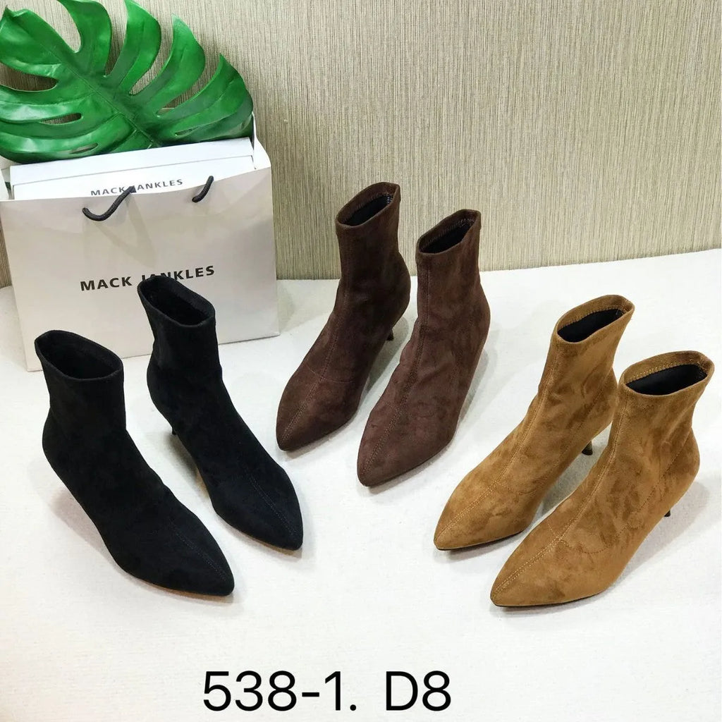Black pointed toe ankle boots with high stiletto heel and mid-calf shaft showing microfiber texture