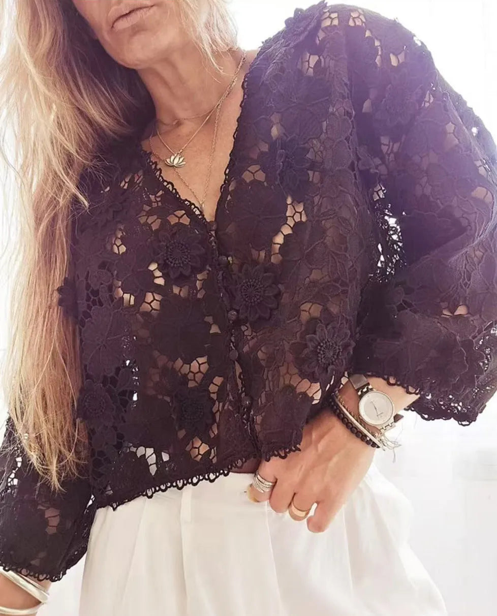 Black lace v-neck cardigan with three-dimensional white flower decorations on the sleeves.