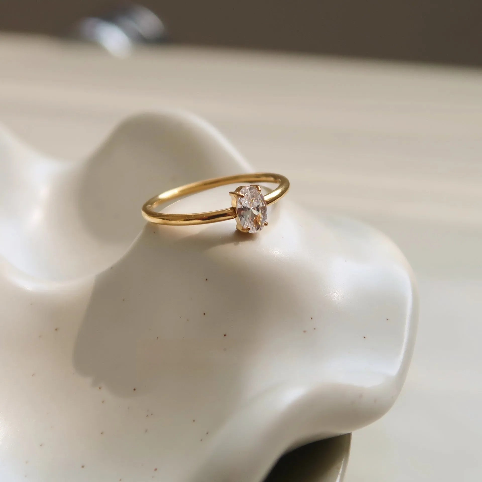 Golden stainless steel ring showing heart shape and oval style options for women in multiple sizes
