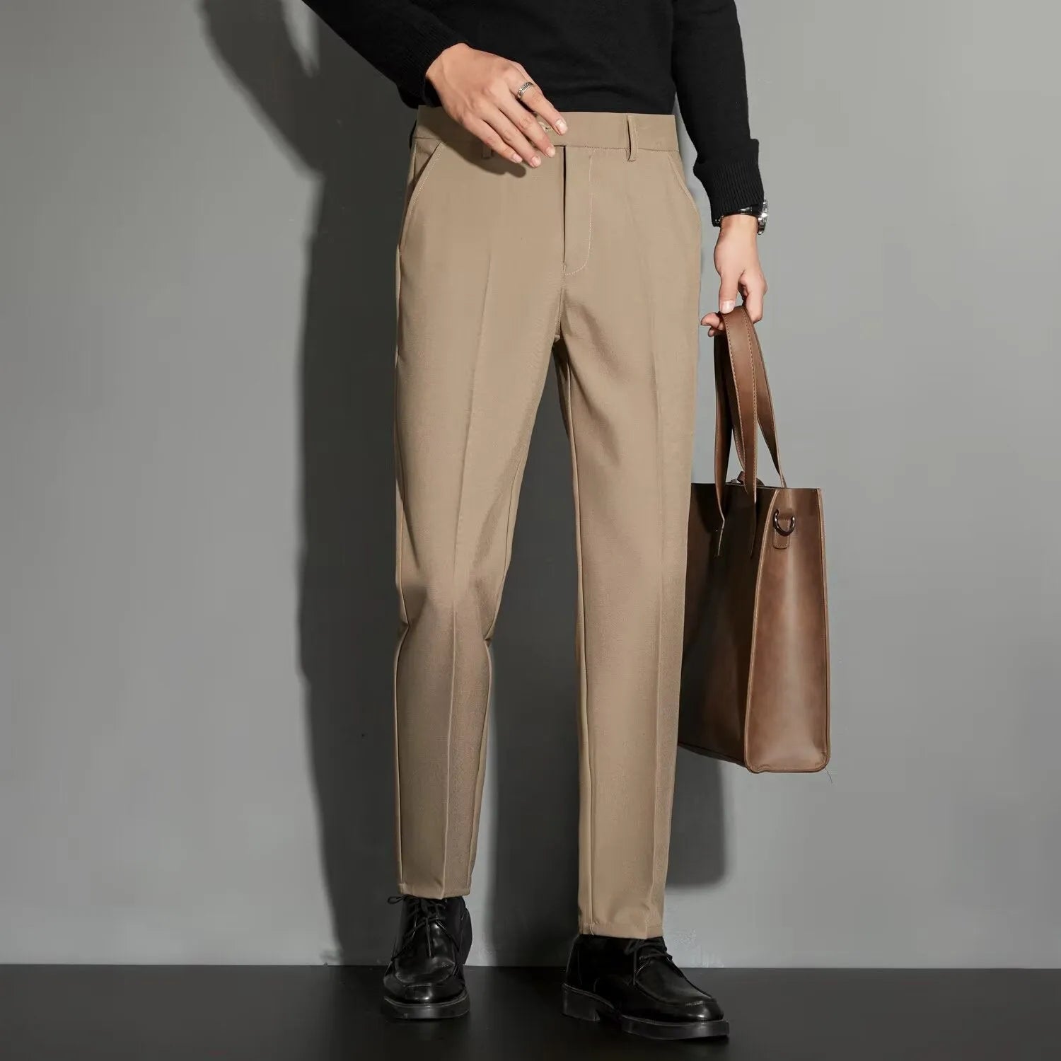 Men's straight-leg ankle-length suit trousers in a chemical fibre blend fabric shown in a classic colour.