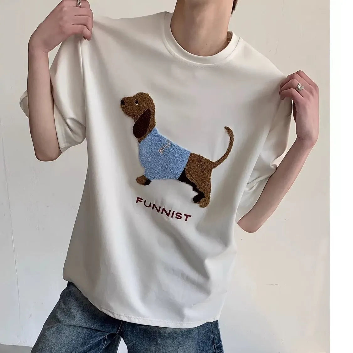 Grey men's round neck T-shirt with an embroidered brown sausage dog design on the front.