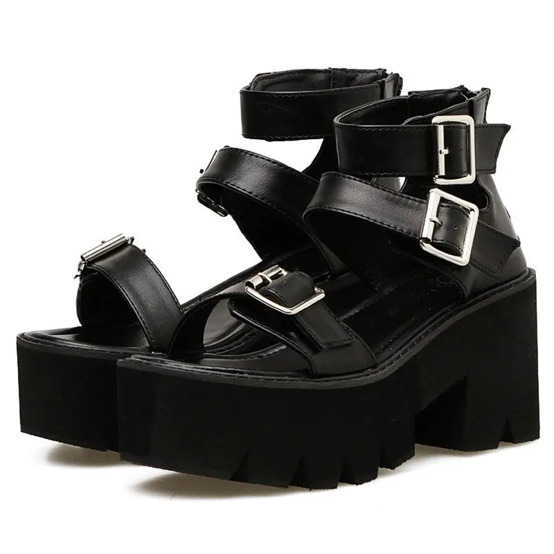 Black women's punk-style chunky heel platform sandals with round toe and buckle detail.