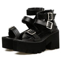 Black women's punk-style chunky heel platform sandals with round toe and buckle detail.