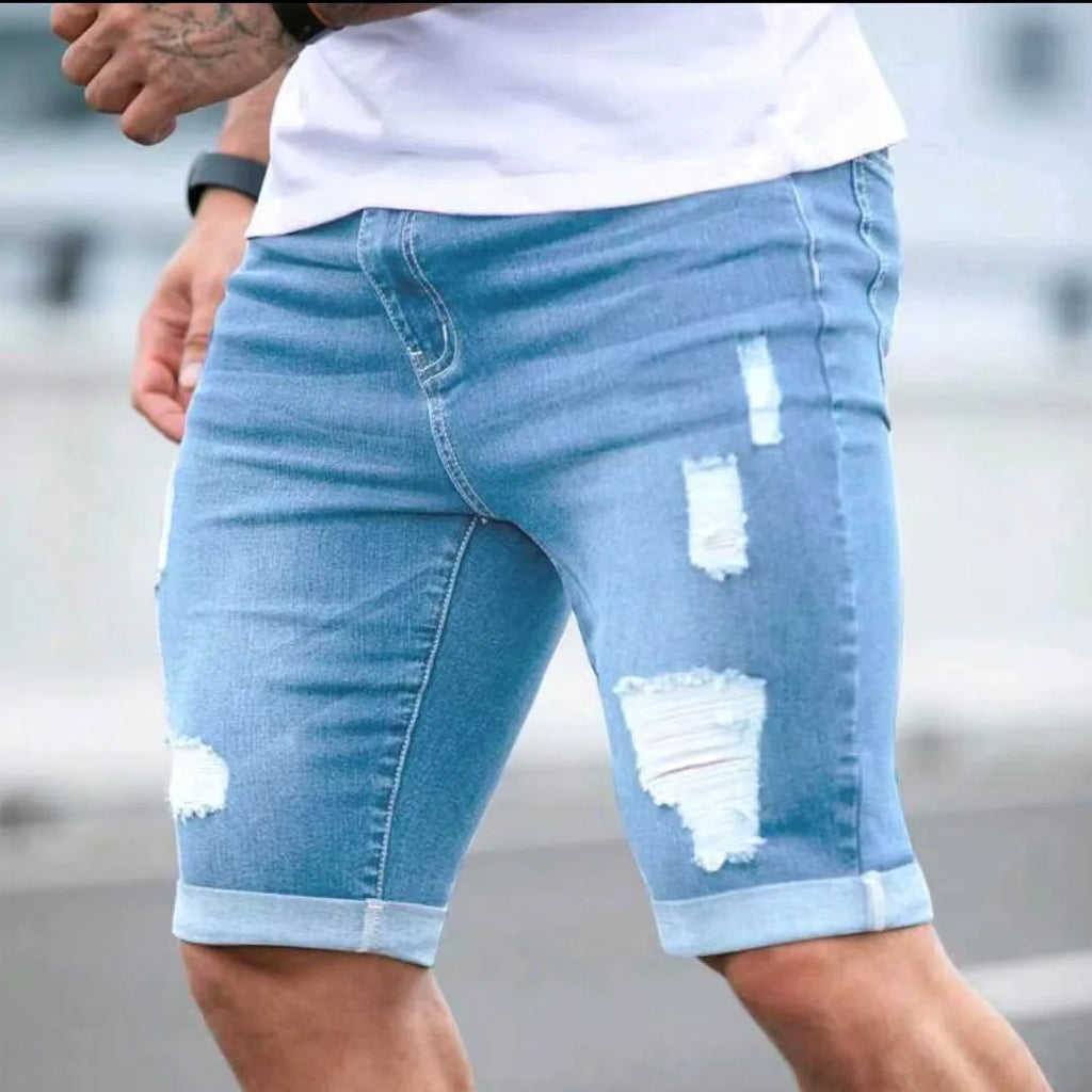 Sky blue distressed denim shorts with low-rise waist and zip fly closure