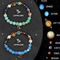Two natural stone beaded bracelets showing zodiac sign designs, presented as a set.