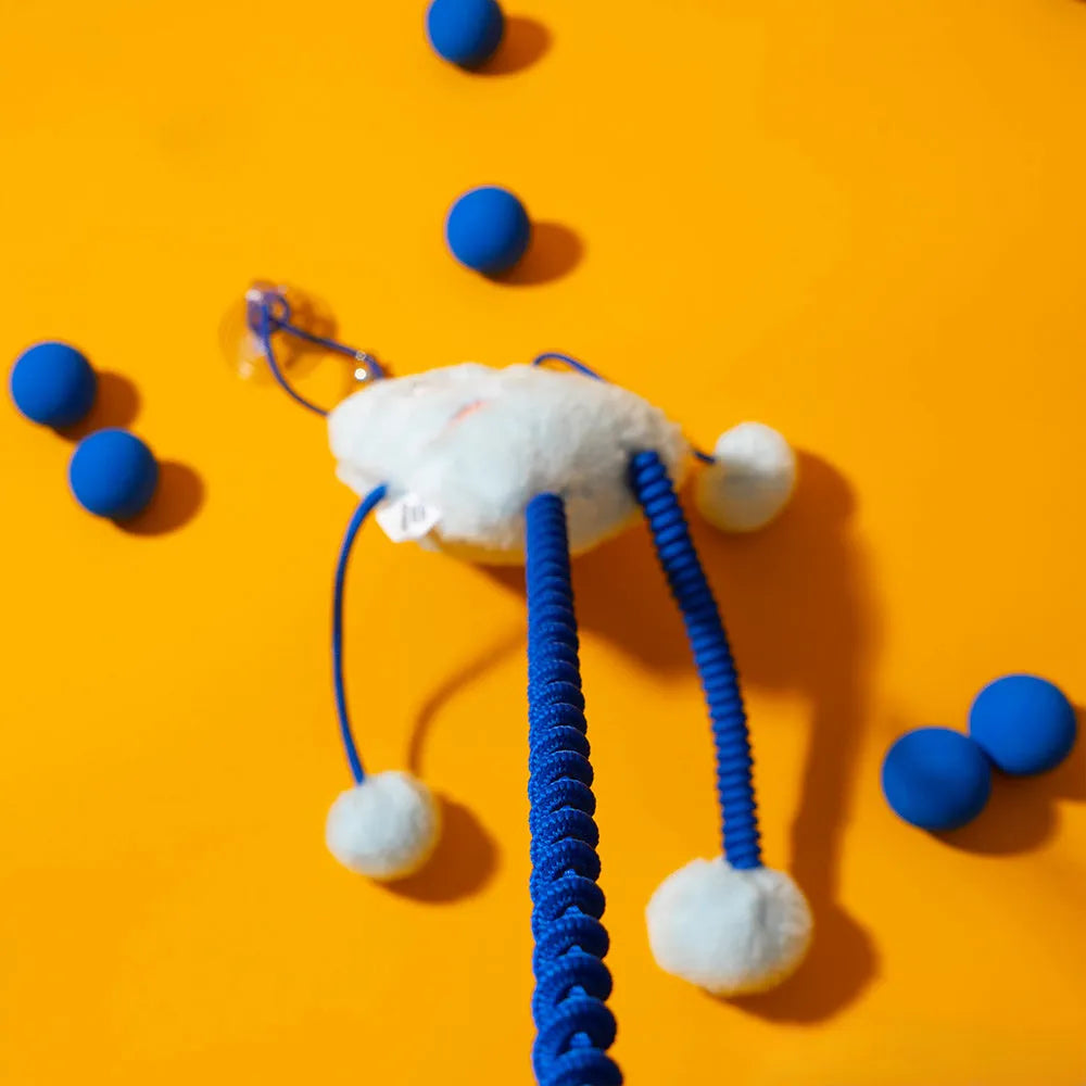 Blue telescopic elastic cat toy with plush mint-scented ring bell attachment extended during play