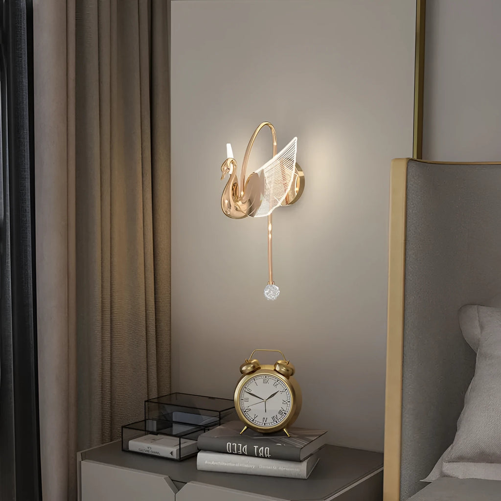 Gold swan-shaped LED wall lamp with acrylic shade and iron construction for bedroom lighting