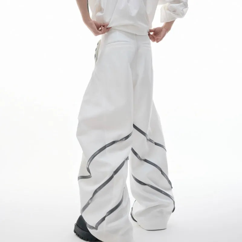 Men's black trousers with metal striped rivets and pleated design detail