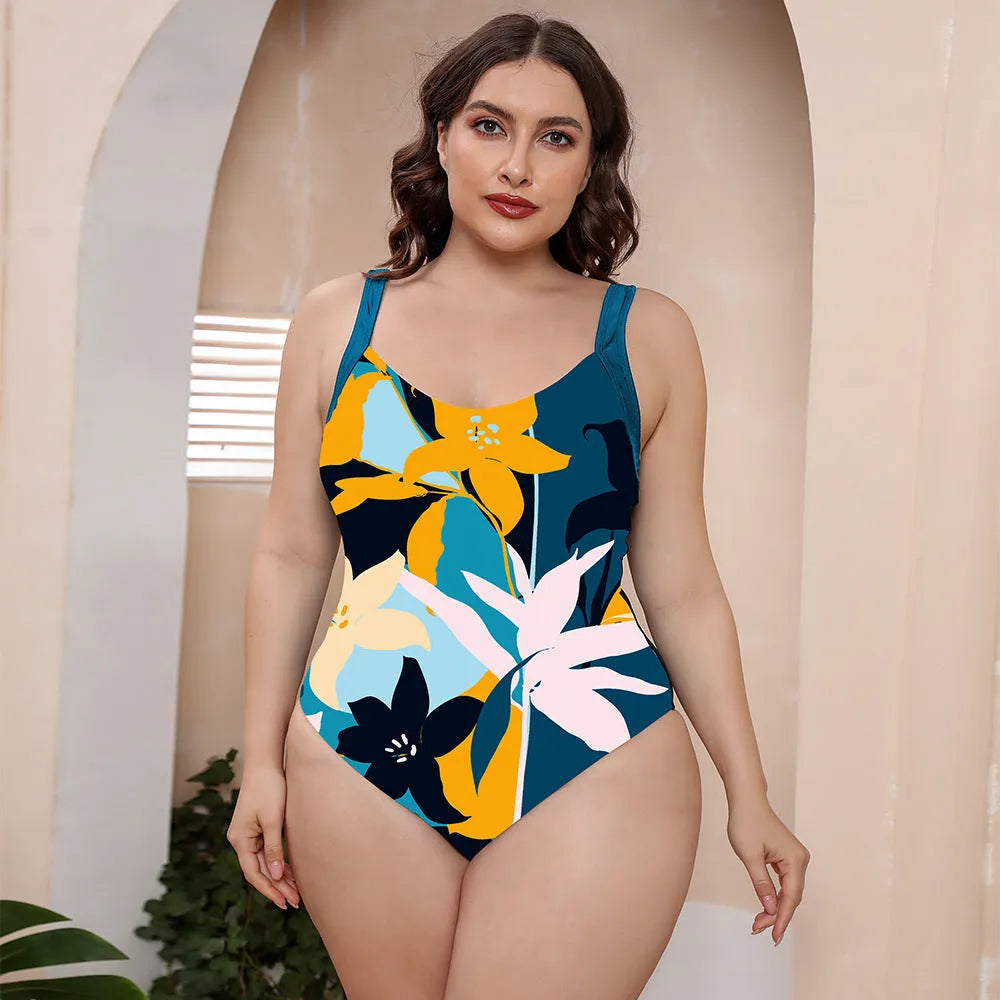 Conservative one-piece floral print swimsuit with spaghetti straps on a mannequin.