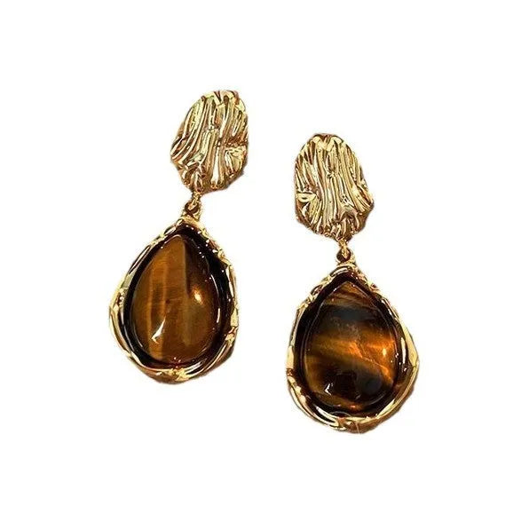 Three pairs of handmade geometric holiday earrings with tassels: irregular, water drop, and round designs.