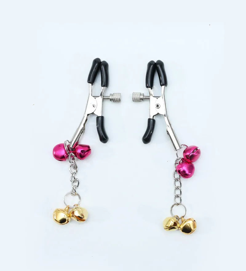 Red bell nipple clamp pair with chain attachment on a dark background