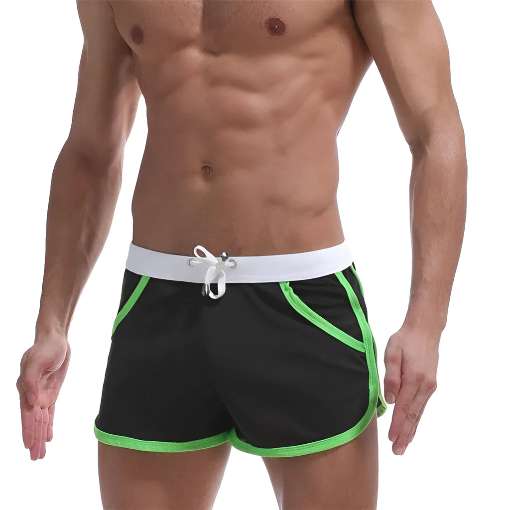 Summer men's quick-dry polyester sports shorts in multiple colours including black, green, and red for beach and casual wear.