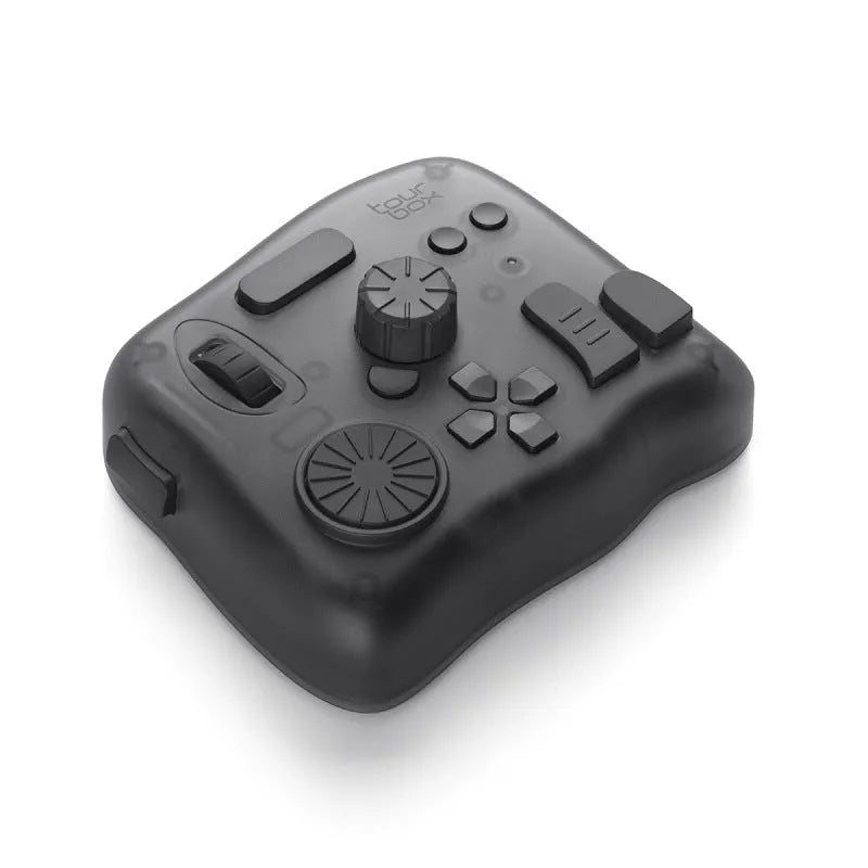 TourBox NEO black USB auxiliary keyboard for video editing on a desk, showing dials and buttons.