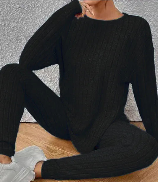 Black sunken stripe polyester two-piece loungewear set with top and pants.