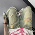 Men's blue denim shorts with a yellow mud distressed finish, rips, loose five-point fit, and button cardigan closure.