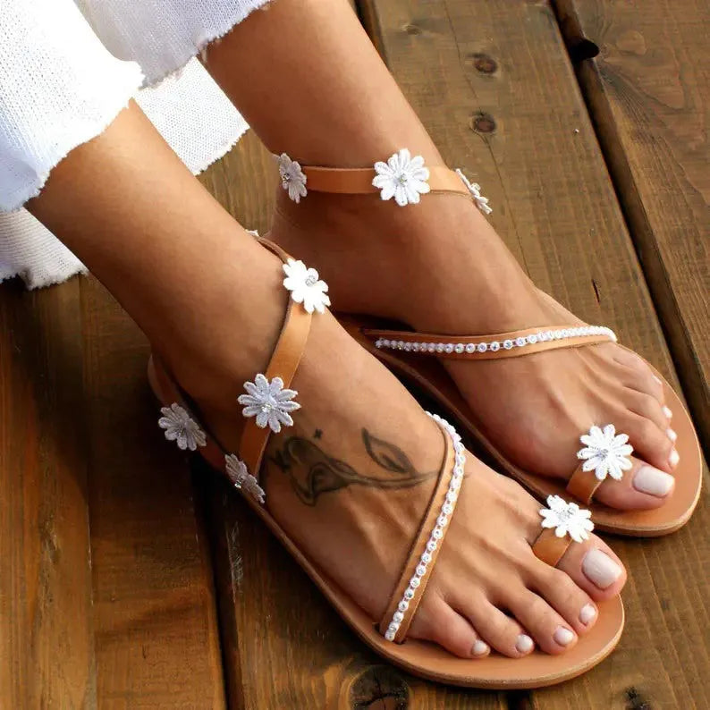 Brown women's Roman sandals with floral decoration and flat rubber sole