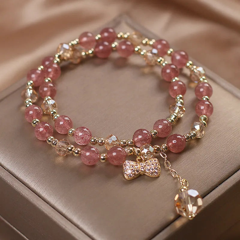 Red double-layer crystal bracelet with Lucky Cat charm and floral beads on wrist