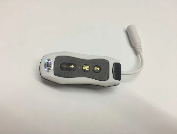 Compact black Bluetooth MP3 headset with USB cable, shown next to scale for size.