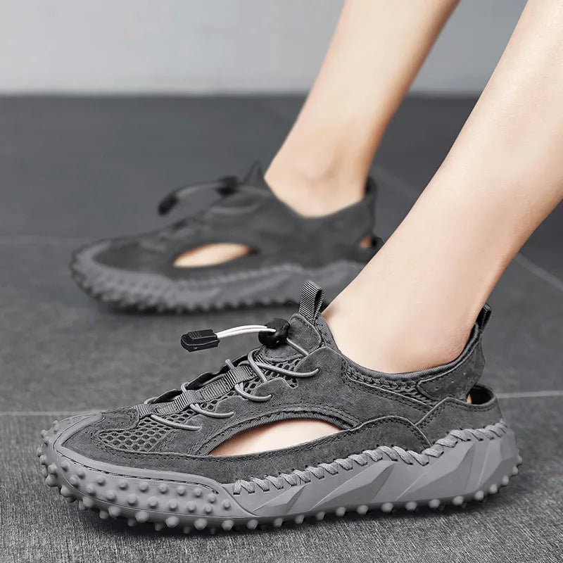 Men's black sports sandals with leather mesh upper, elastic band and non-slip rubber sole.