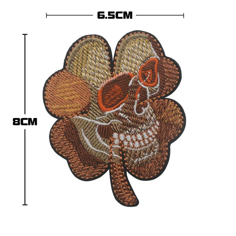Embroidered fabric badge with Velcro backing showing detailed clover leaf pattern in green thread