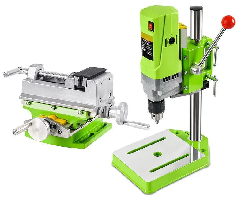 Mini bench drill and milling machine with included 1050W drill and metal bench pliers on a workbench.