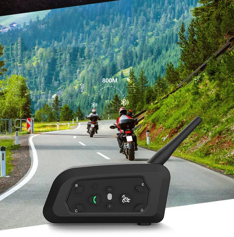 V6 Pro motorcycle Bluetooth intercom unit with mounting clip and charging cable on a motorcycle handlebar.