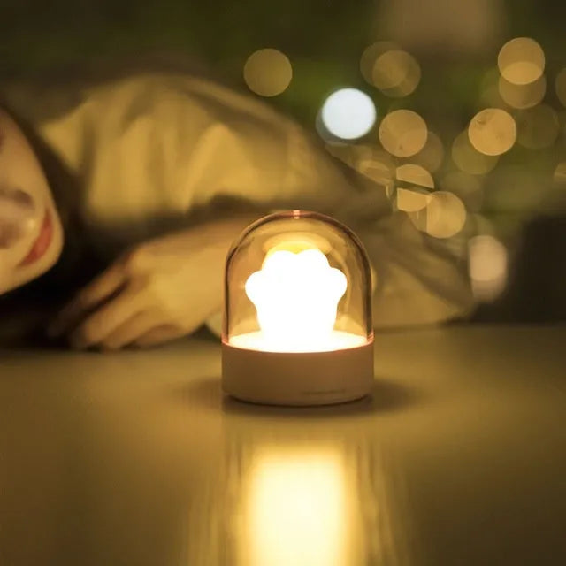 Cat paw-shaped night light with music box function showing pink colour option with illuminated soft light
