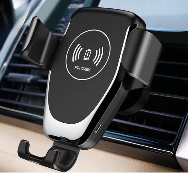 Black Qi wireless car charger mounted on a car dashboard, holding an iPhone.