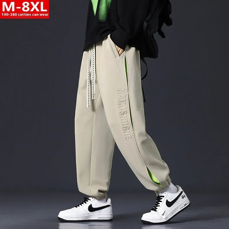 Men's loose fit cotton trousers with banded ankle and collage stitching detail in grey green