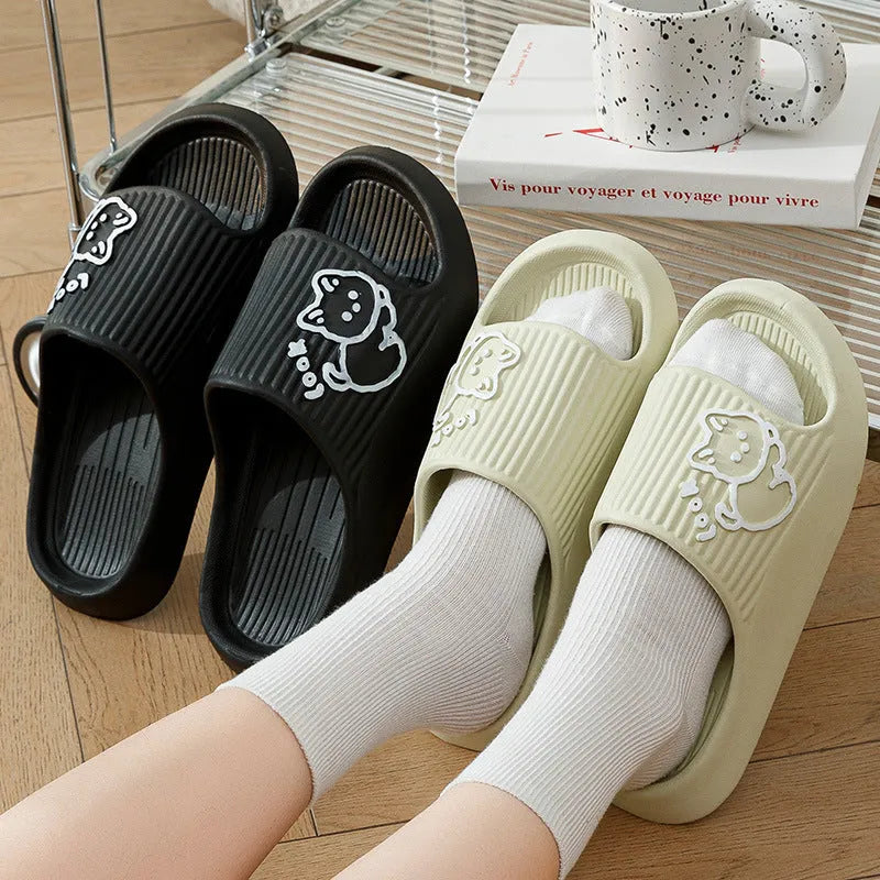 Women's cat platform slippers in pink with thick EVA sole, shown on a wooden floor.