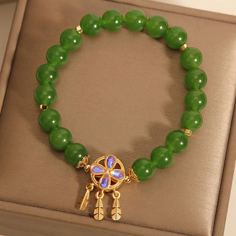 Green Jasper Crystal four-leaf clover dreamcatcher pendant on a women's bracelet.