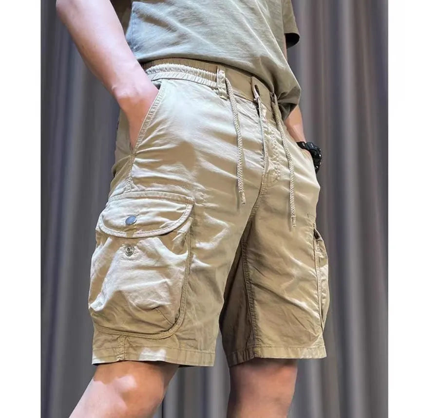 A pair of loose straight leg casual overalls with multiple front pockets, shown in a khaki colour.