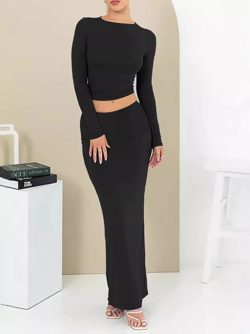 Women's slim fit polyester two-piece suit set with three-quarter sleeves and long skirt in black.