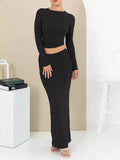 Women's slim fit polyester two-piece suit set with three-quarter sleeves and long skirt in black.