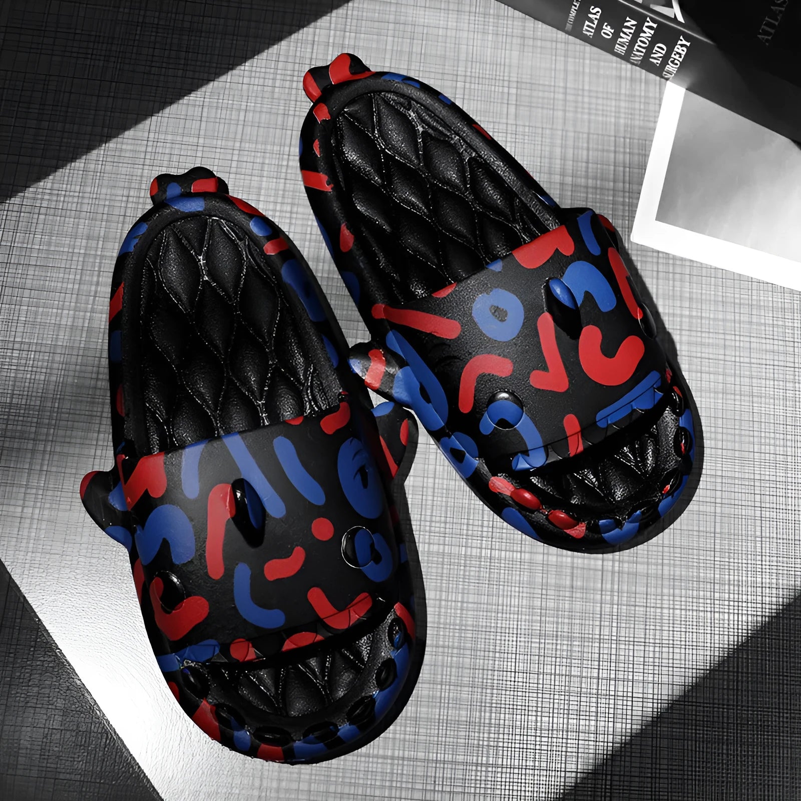 Pair of light beige open-toe EVA slippers with a shark design on a white background.