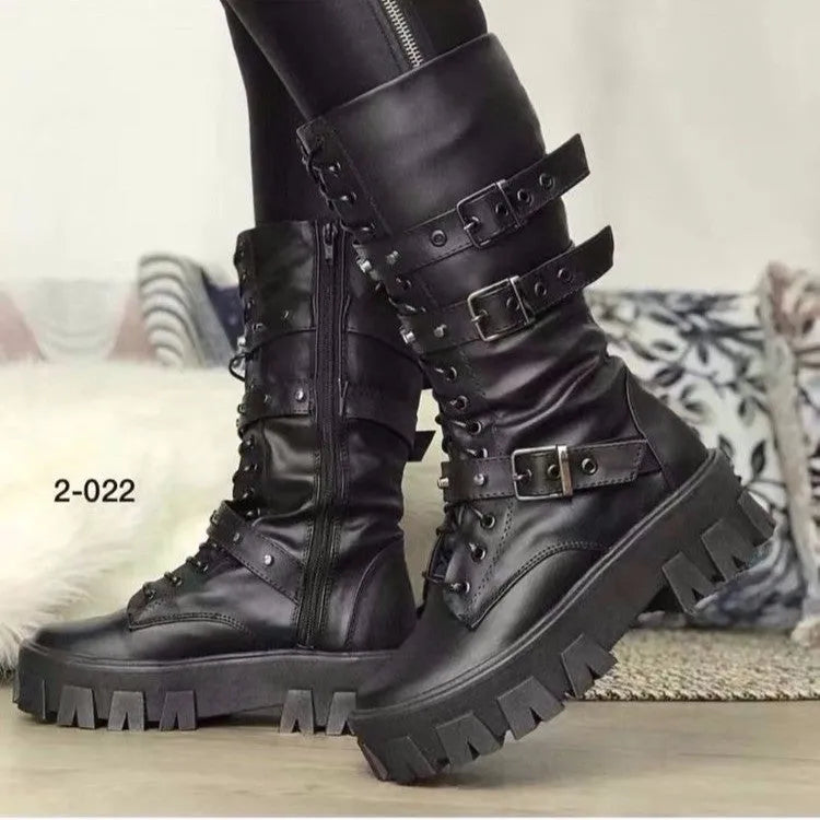 A pair of black mid-calf women's boots with metal buckle details and a side zipper on a white background.