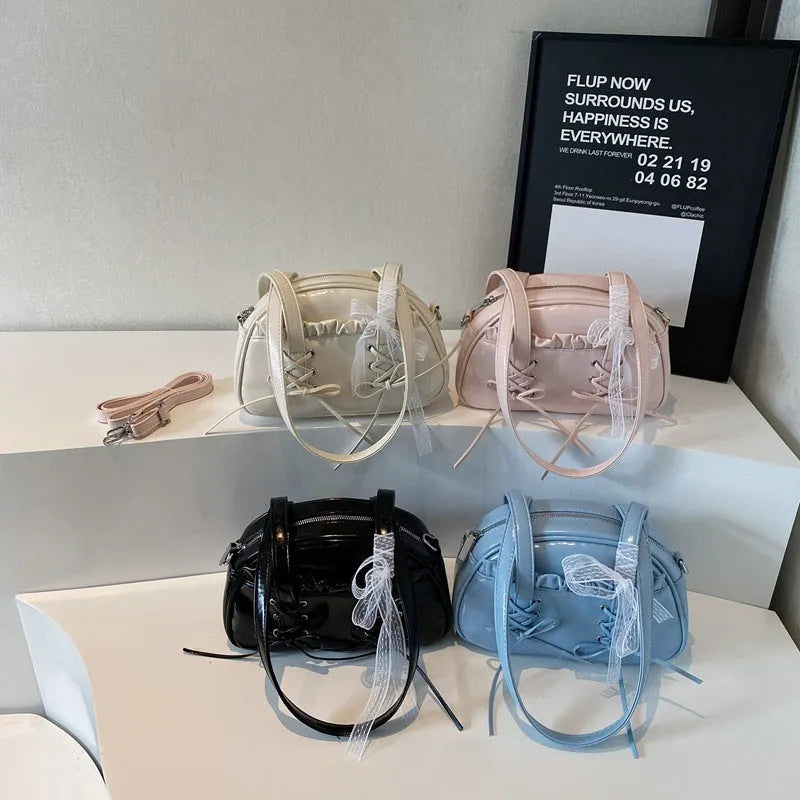 Women's casual shoulder bag in PU leather with a white bandage bow design on the front.