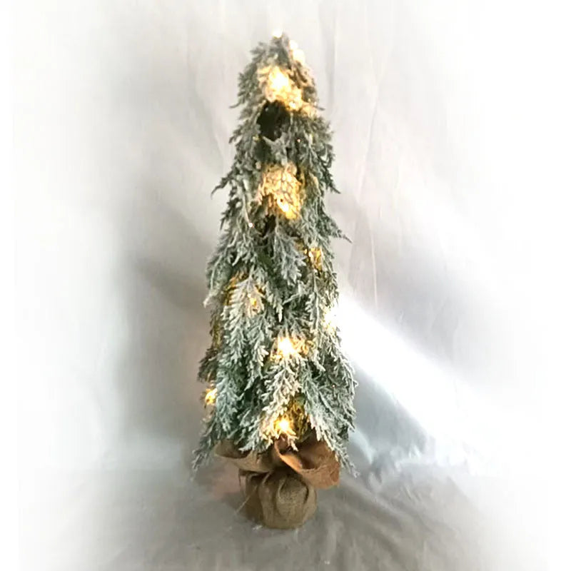 Small 24-inch artificial Christmas tree with snow-spray branches and built-in lights for desktop decoration