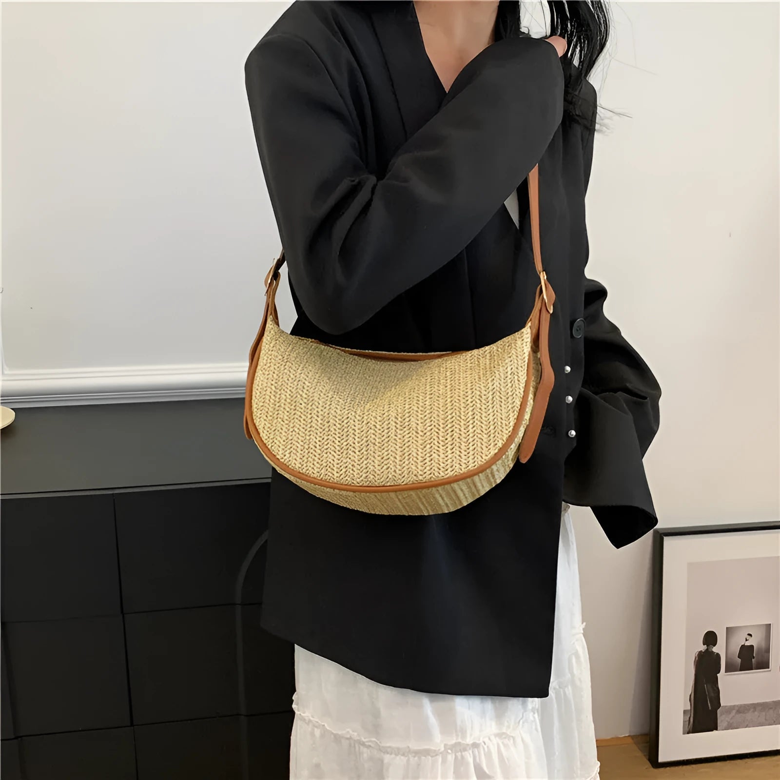 Women's straw woven crossbody bag showing texture and internal phone and file compartments.