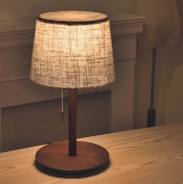Walnut colour solid wood bedside lamp with fabric shade and pull cord switch