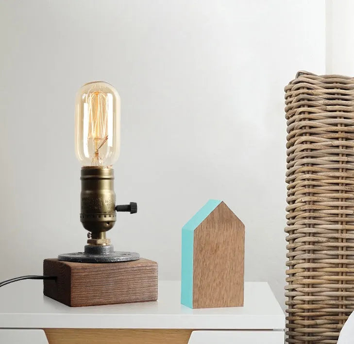 Water pipe design table lamp with wood and iron construction measuring 9 cm wide by 13 cm high